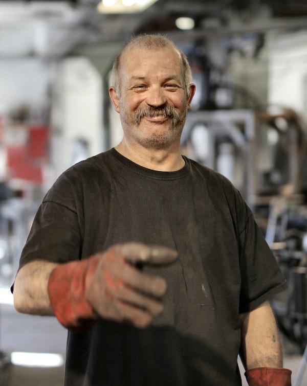 happy-elderly-worker-smiling-in-workshop-3846508 (1)